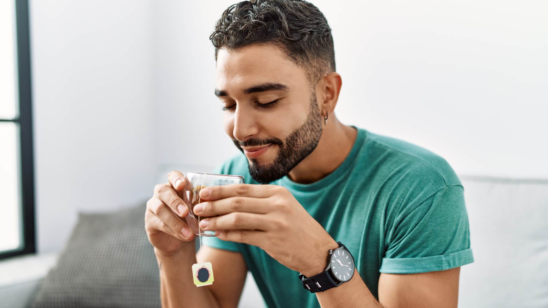 man drinking coffee in a mug at home