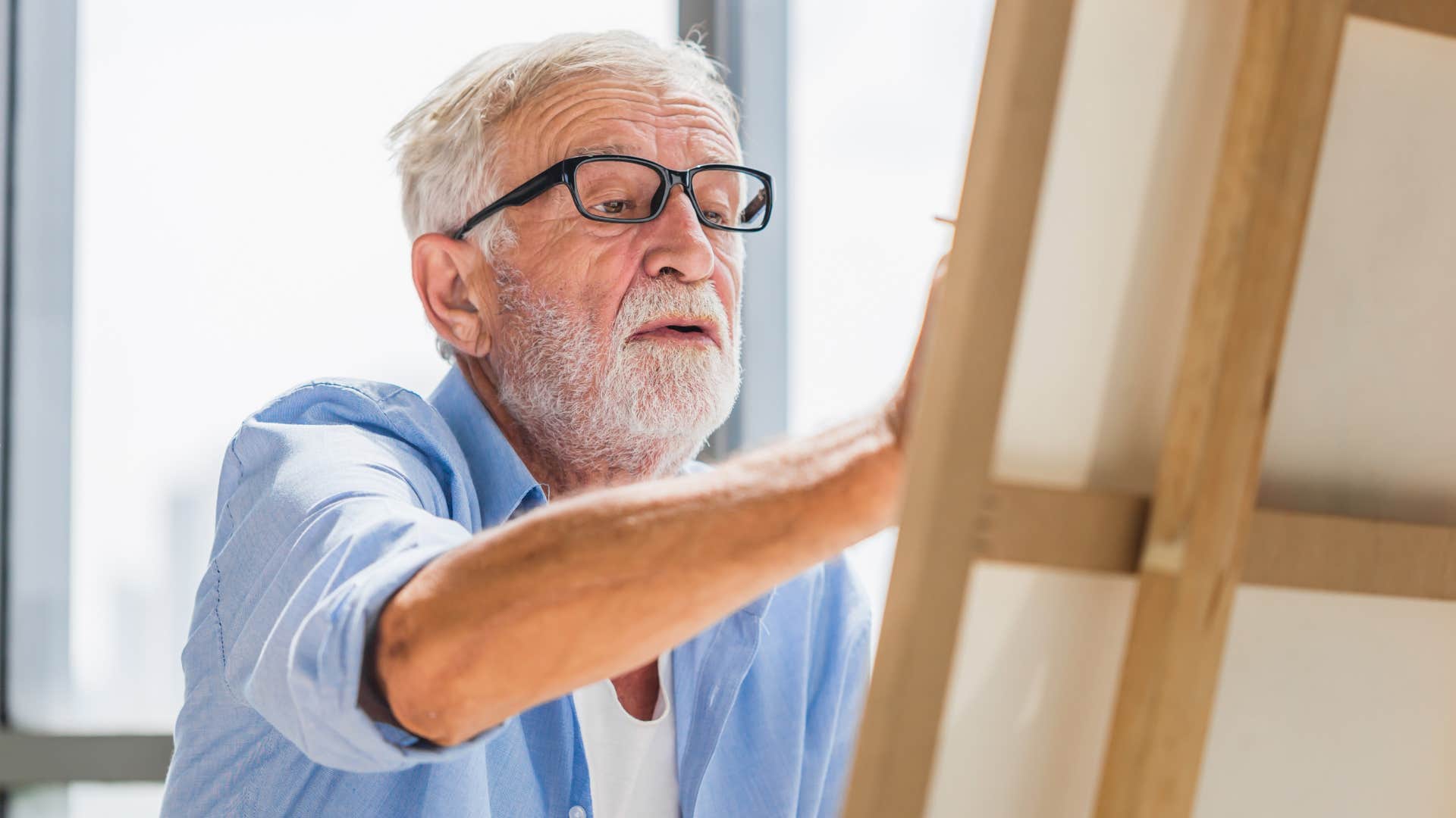 good man painting at home as a creative outlet