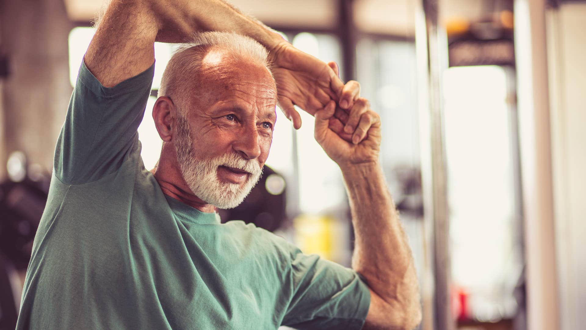 man stretching for intentional movement at home
