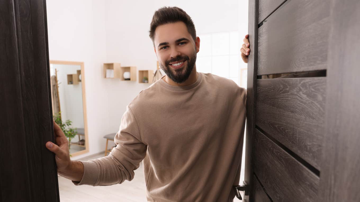 Little Things Good Men Always Have In Their Homes, No Matter Their Income good man smiling in doorway opening up entry to his home