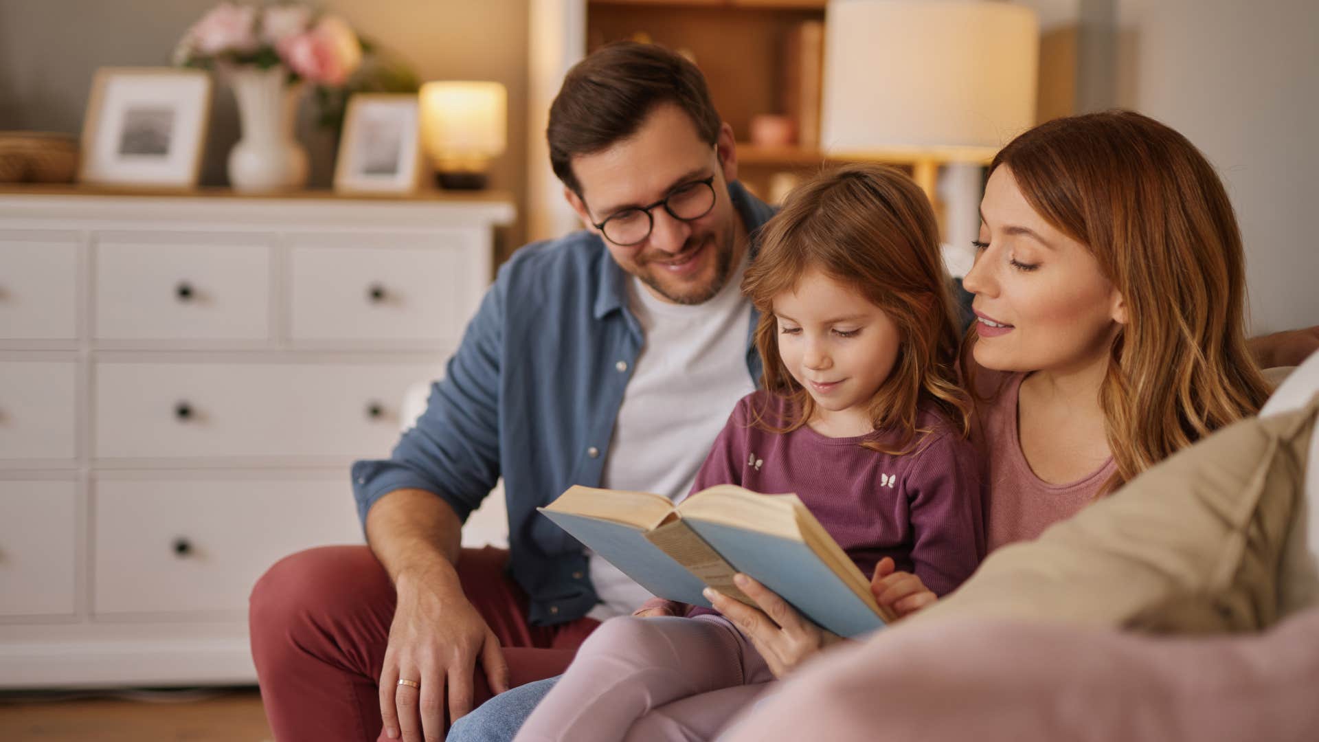 a couple read their daughter one of their many books