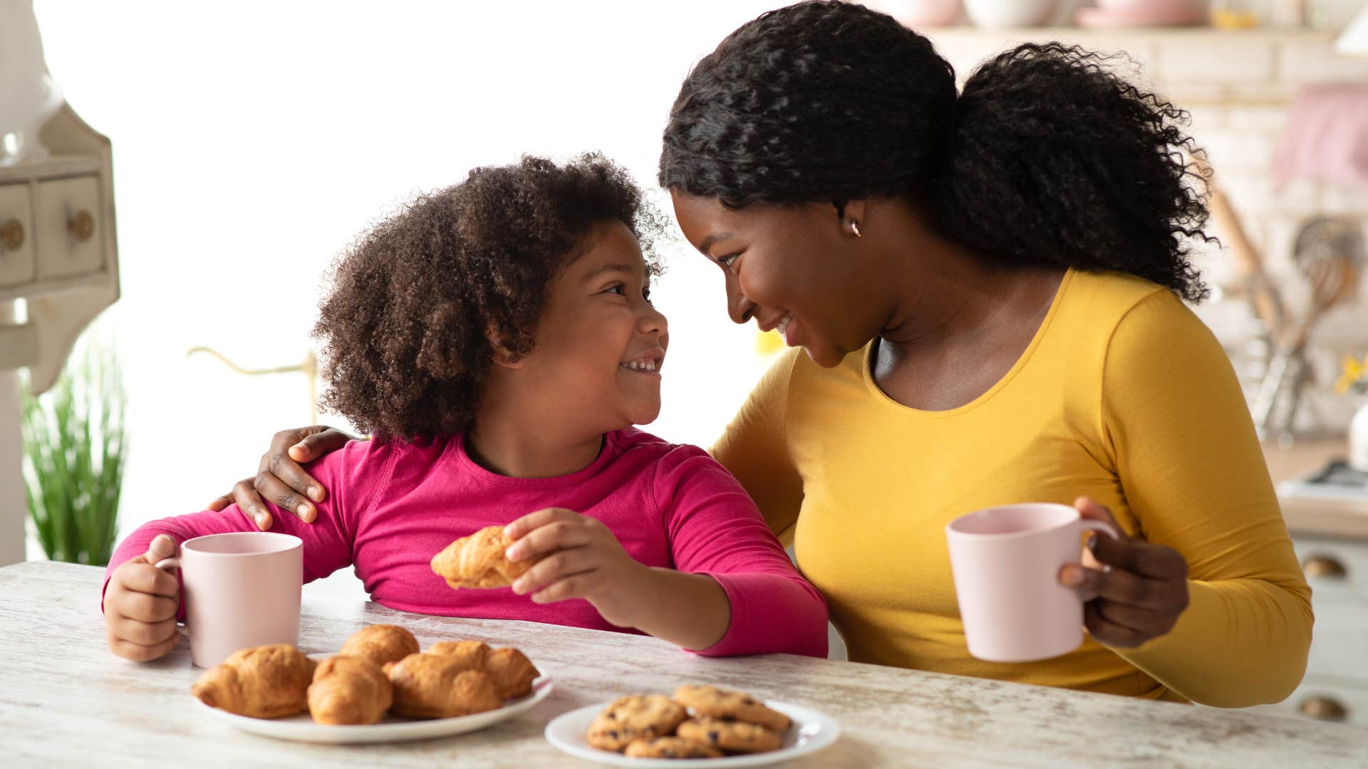 a mother does her little tradition with her daughter where they eat pastries and drink cocoa together