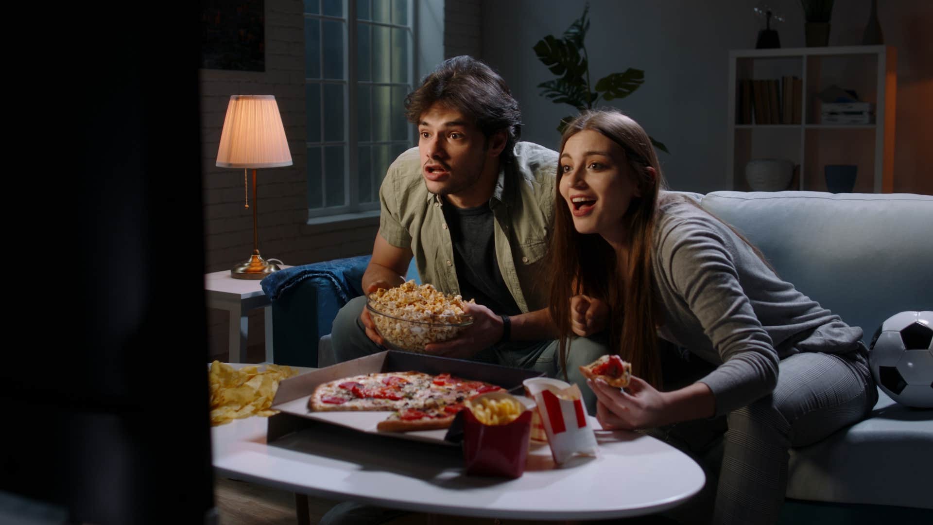 couple who ordered pizza with takeout menu