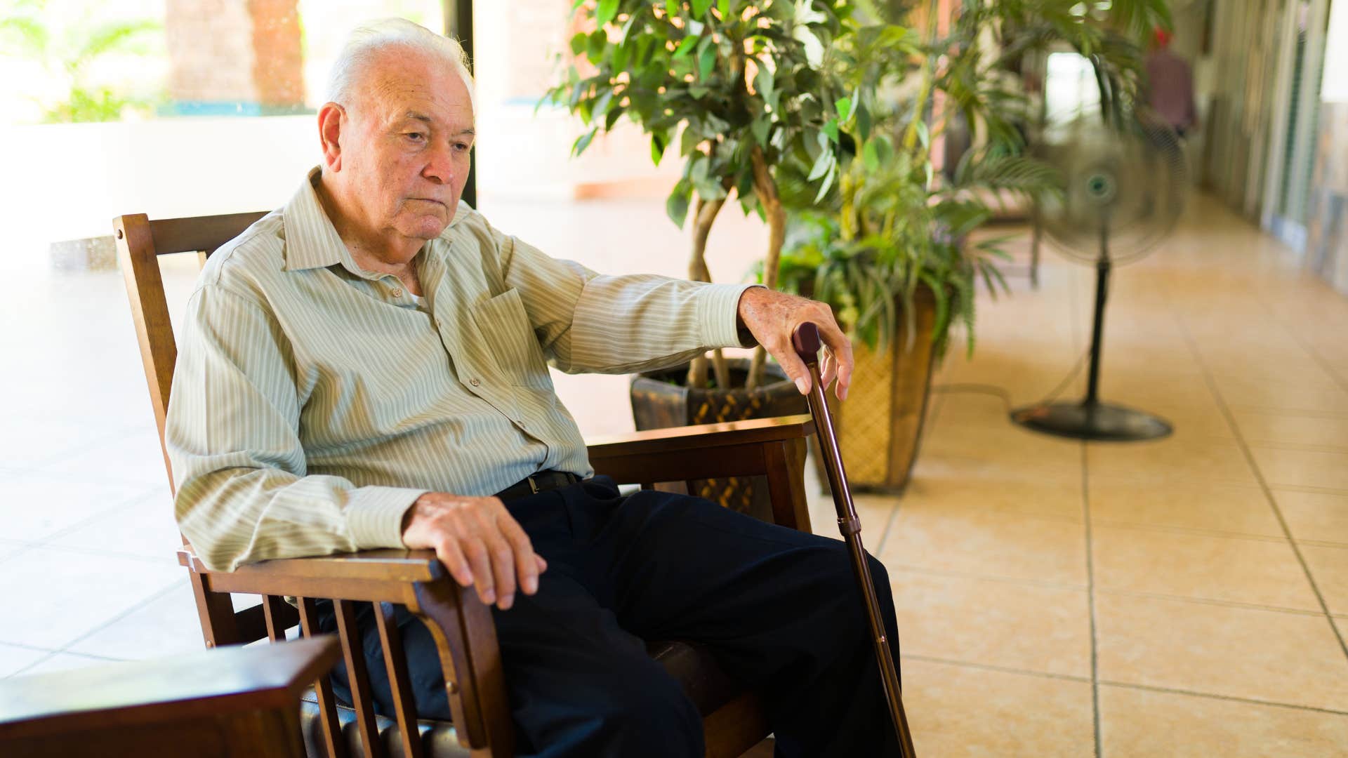man sitting in a rocking chair with light shirt and dark pants