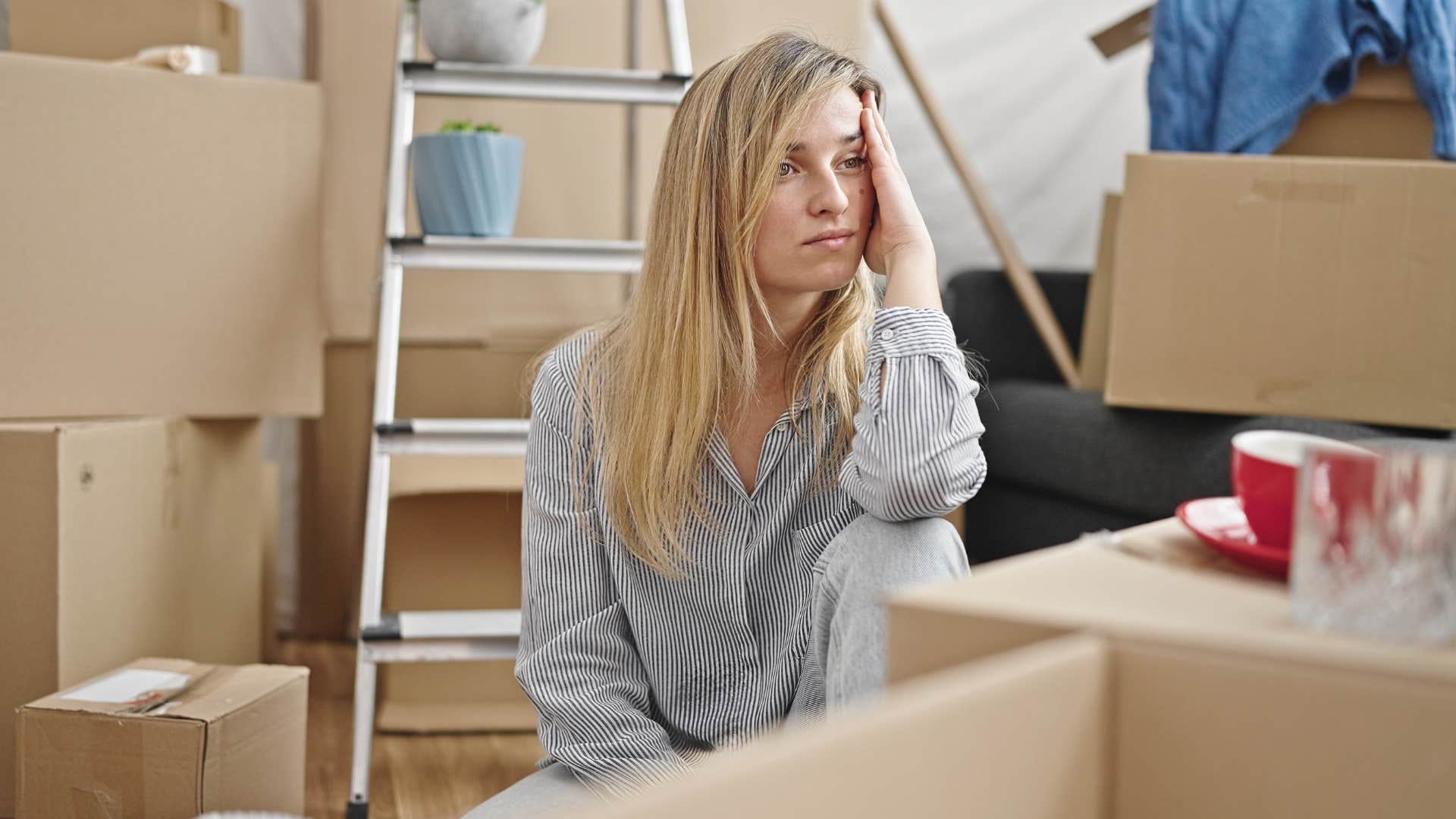a burned out woman looks around all of her unopened mail packages