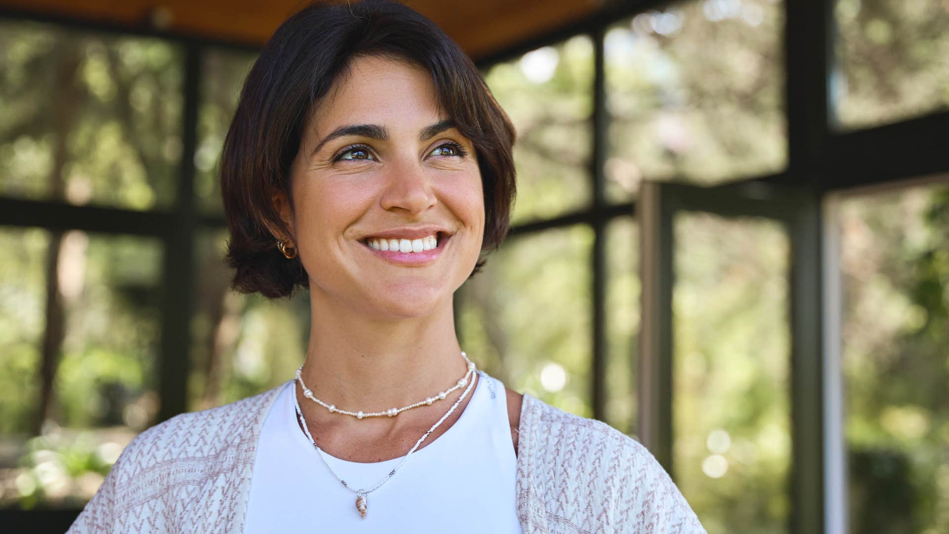 Woman smiling in her space for mindfulness at home.