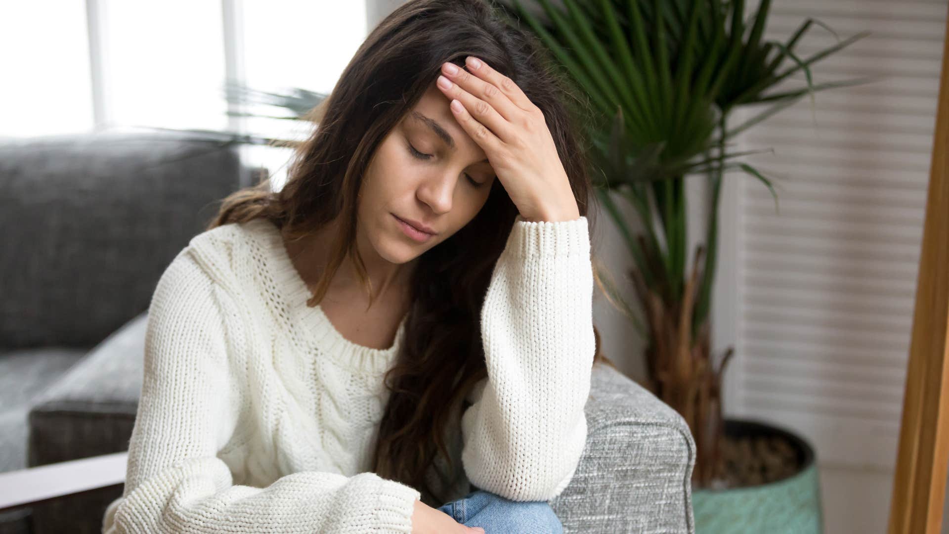 woman anxious about money looking down