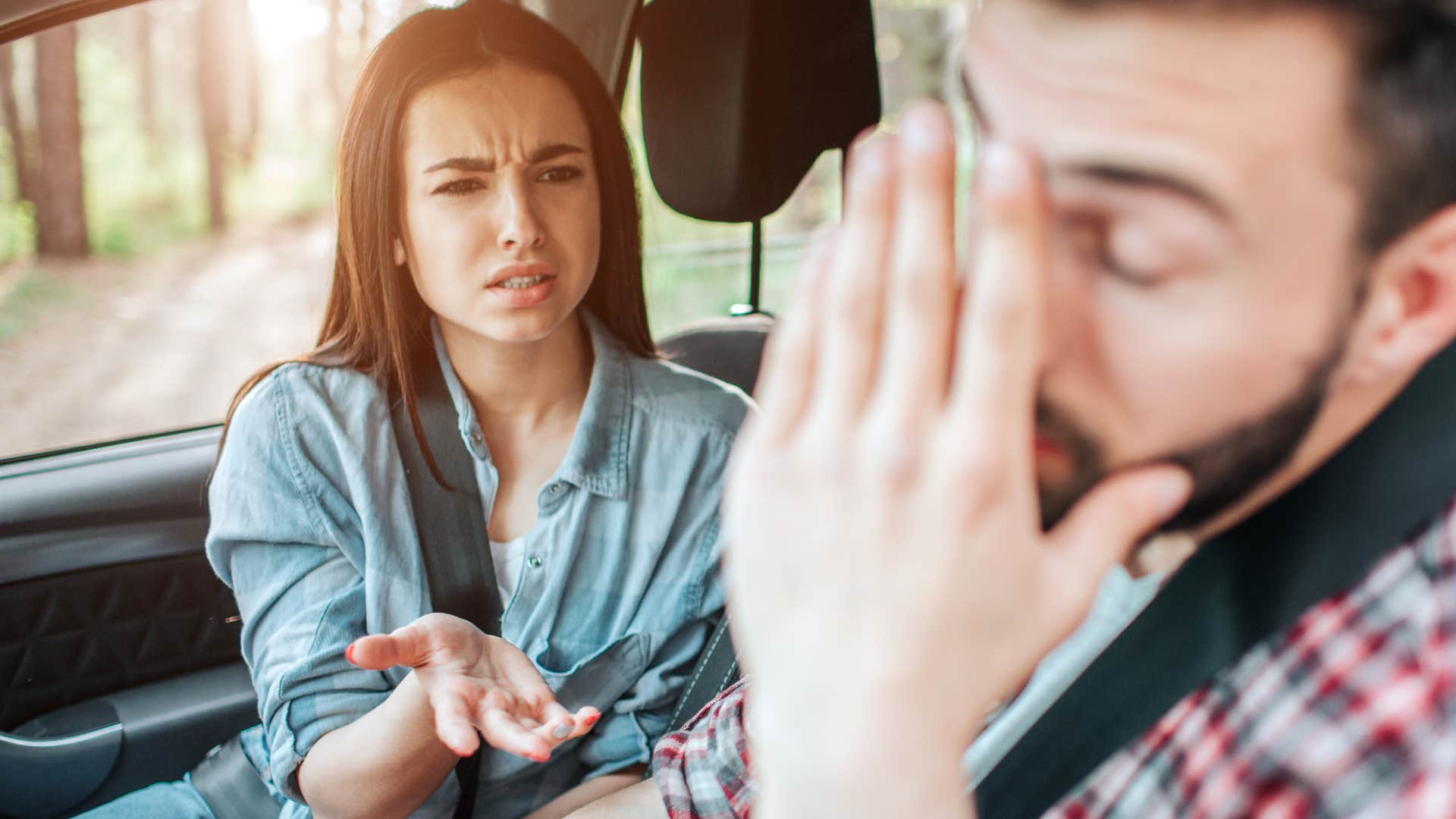 woman arguing with her partner who never fills the gas tank up completely