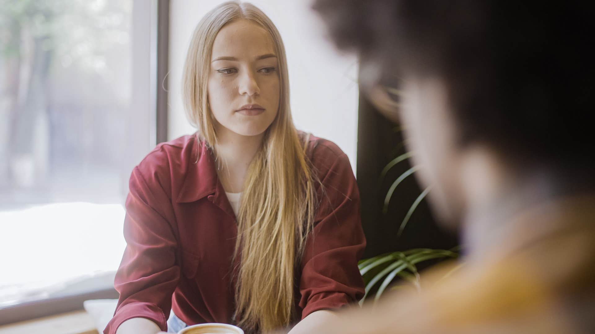 financially stressed woman saying shes not hungry to her friend