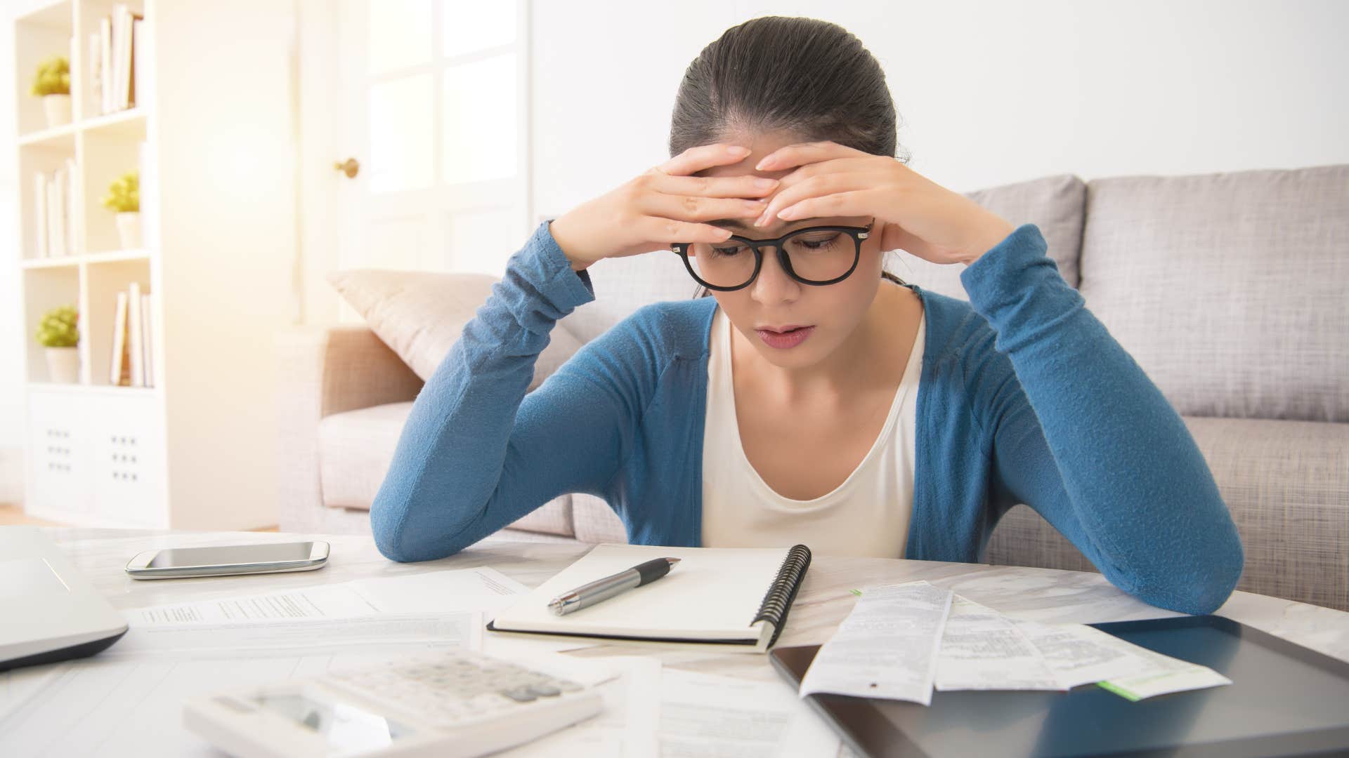 woman paying all her debts on the same day looking stressed