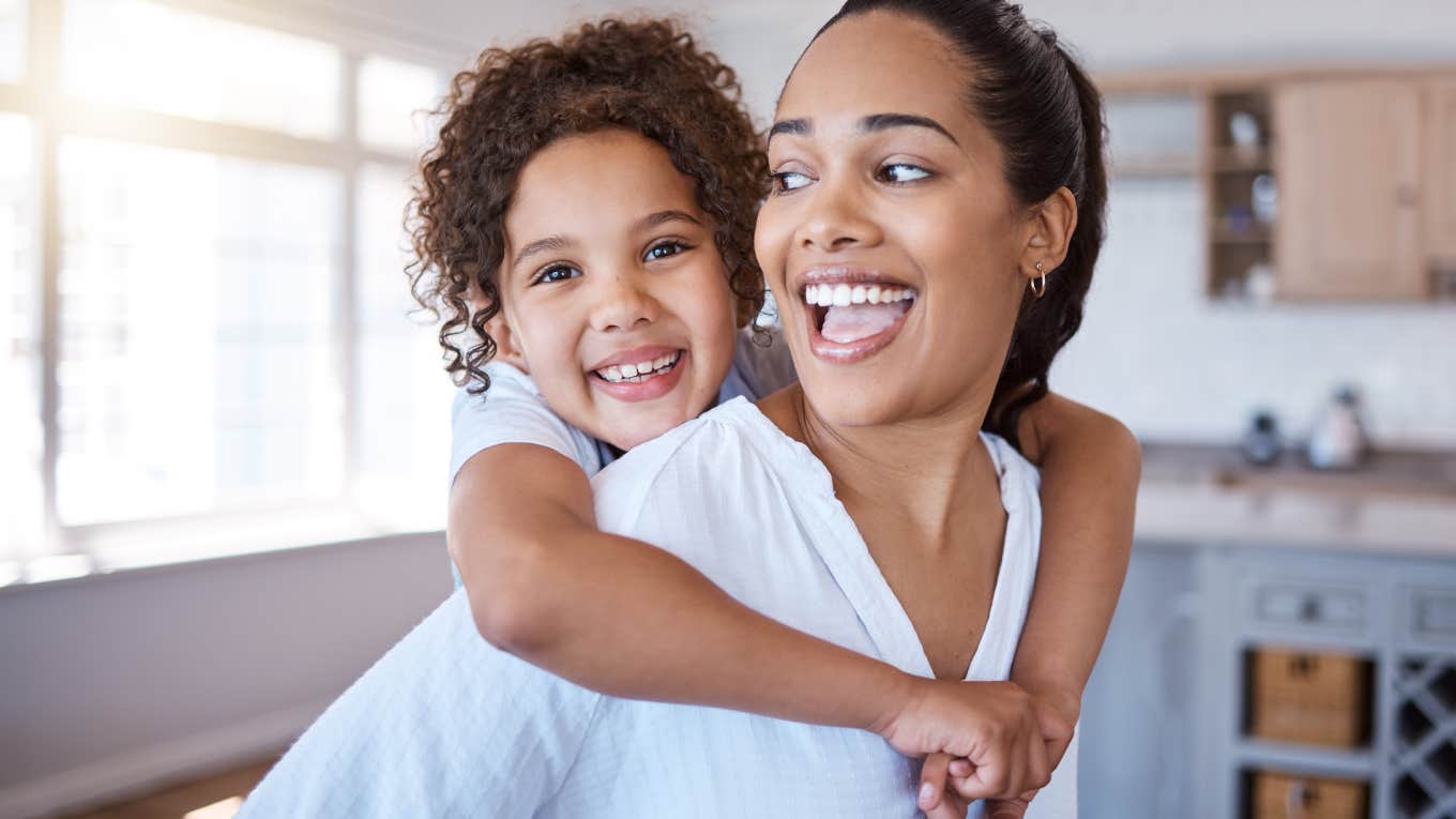 6 Little Ways Your Kid Confirms That You're A Great Parent mom giving daughter piggyback at home