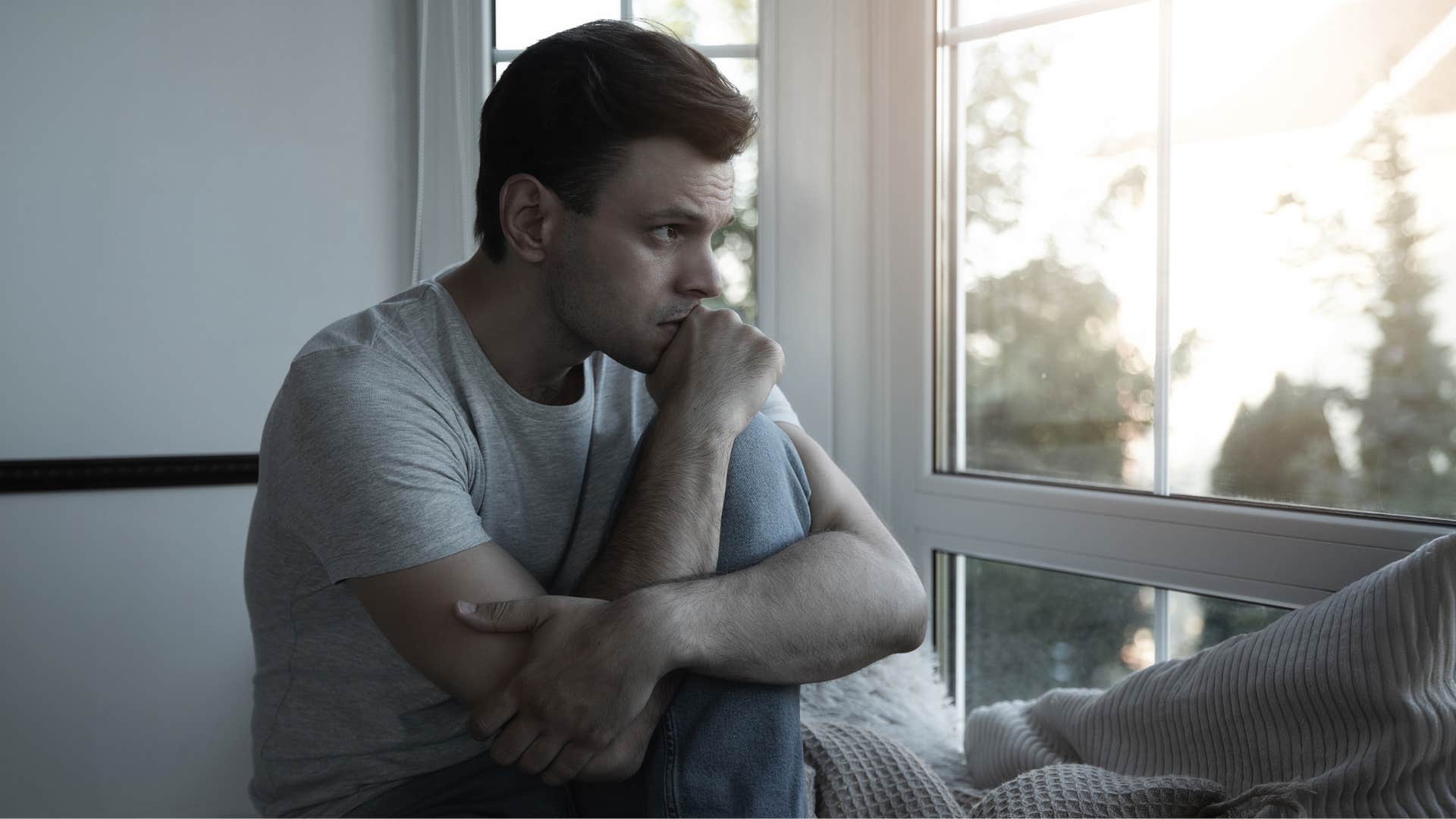 man struggling with depression and anxiety as he deeply reflects