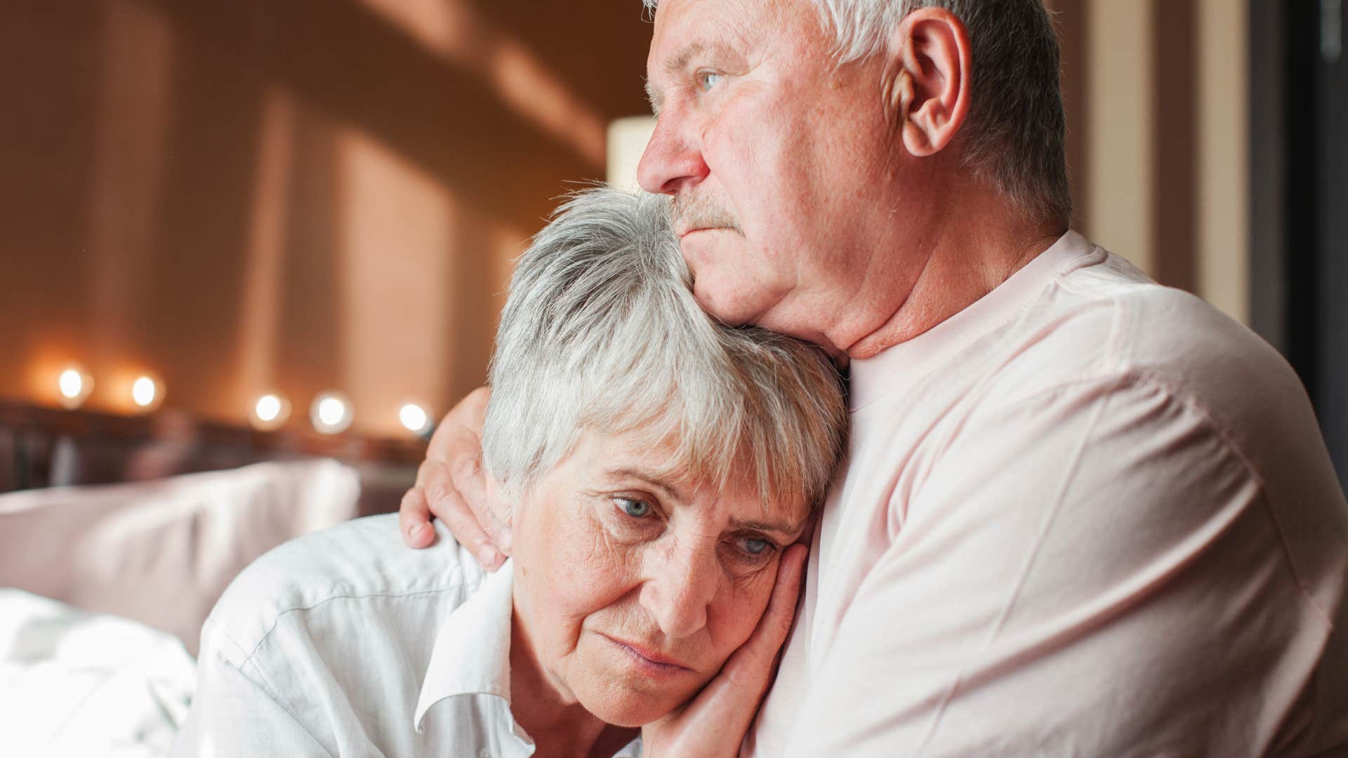 Man whose relationship isn't balanced hugging his wife.