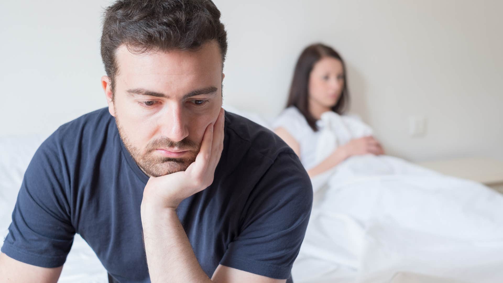 Man thinking about how everything feels stagnant in front of his partner.