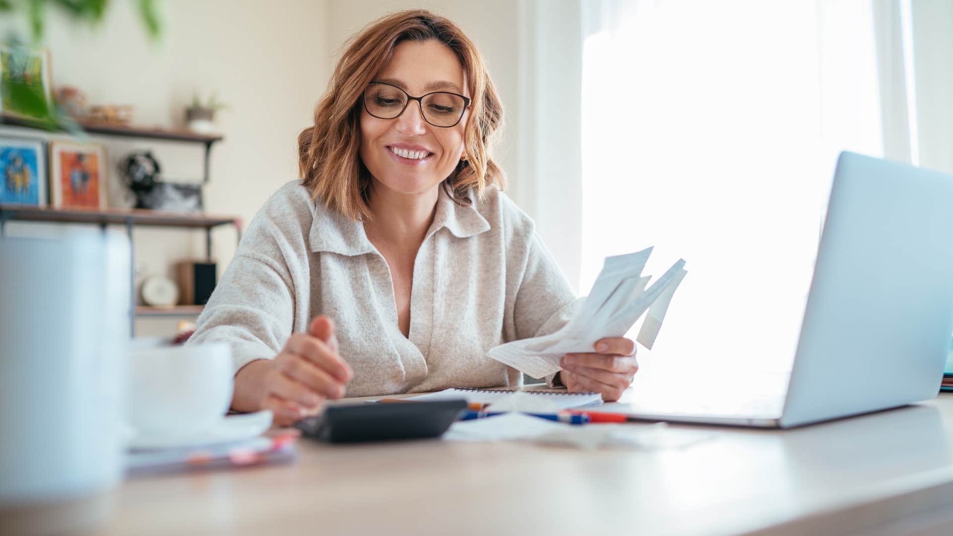 woman who is keeping track of money by budgeting