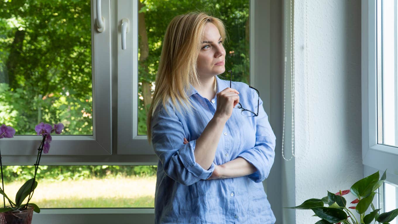 neighbor cut down trees couples backyard flowers falling property woman looking at trees out window