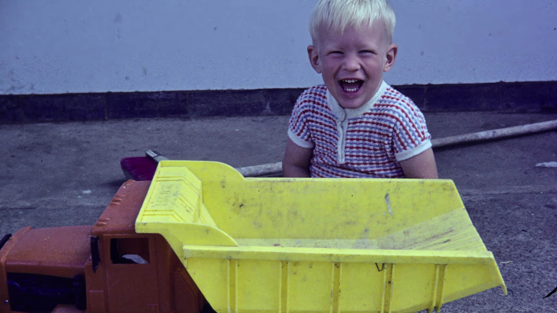 throwback picture of little boy and toy truck