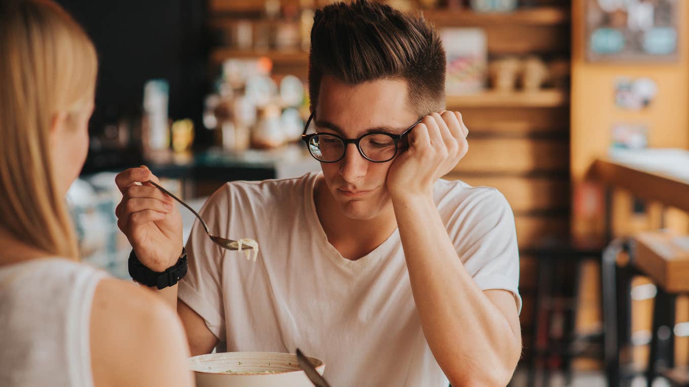 office bully mocks worker for eating kid meals for lunch. Man look said while he eats.