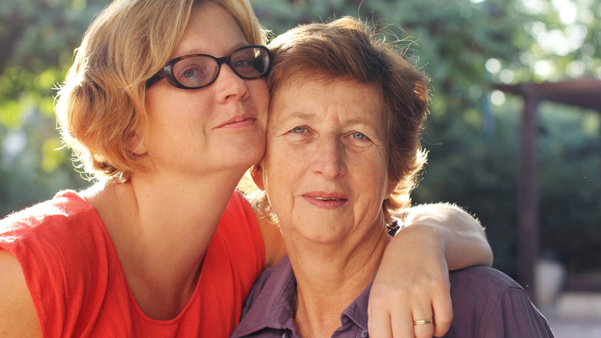 Woman who still need and rely on their parent hugging her mom.