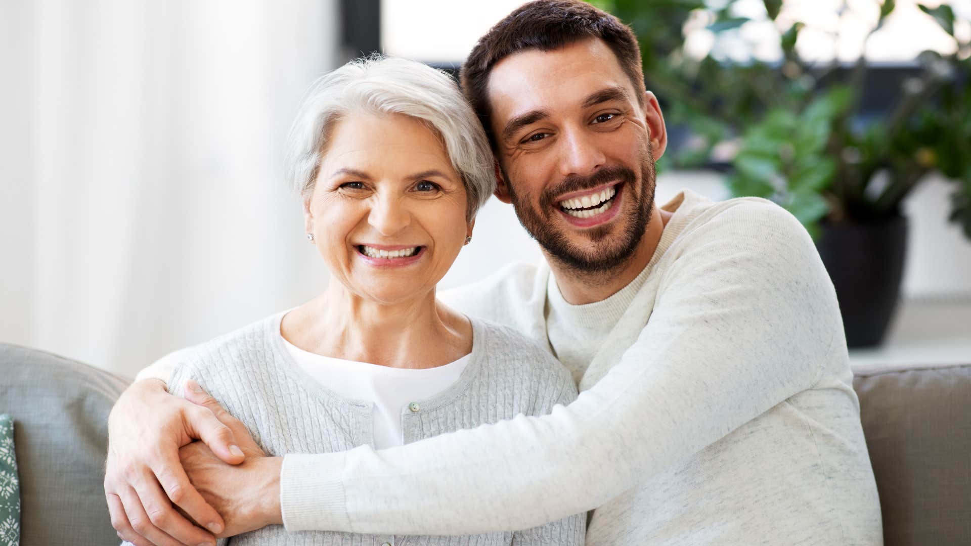 Woman hugging her adult son who live nearby than others.