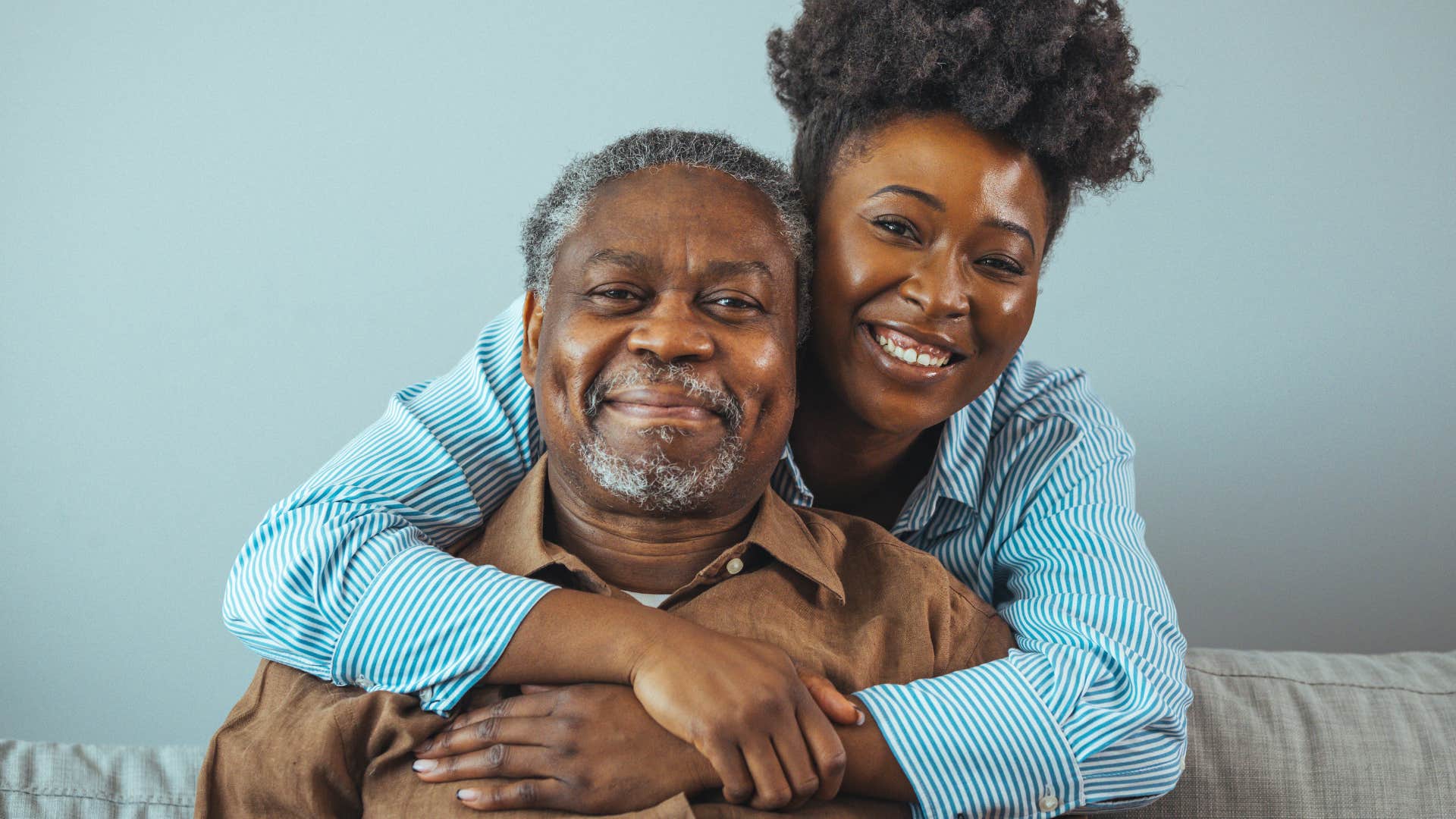 Woman who follow the path the parent hoped for hugging her dad.