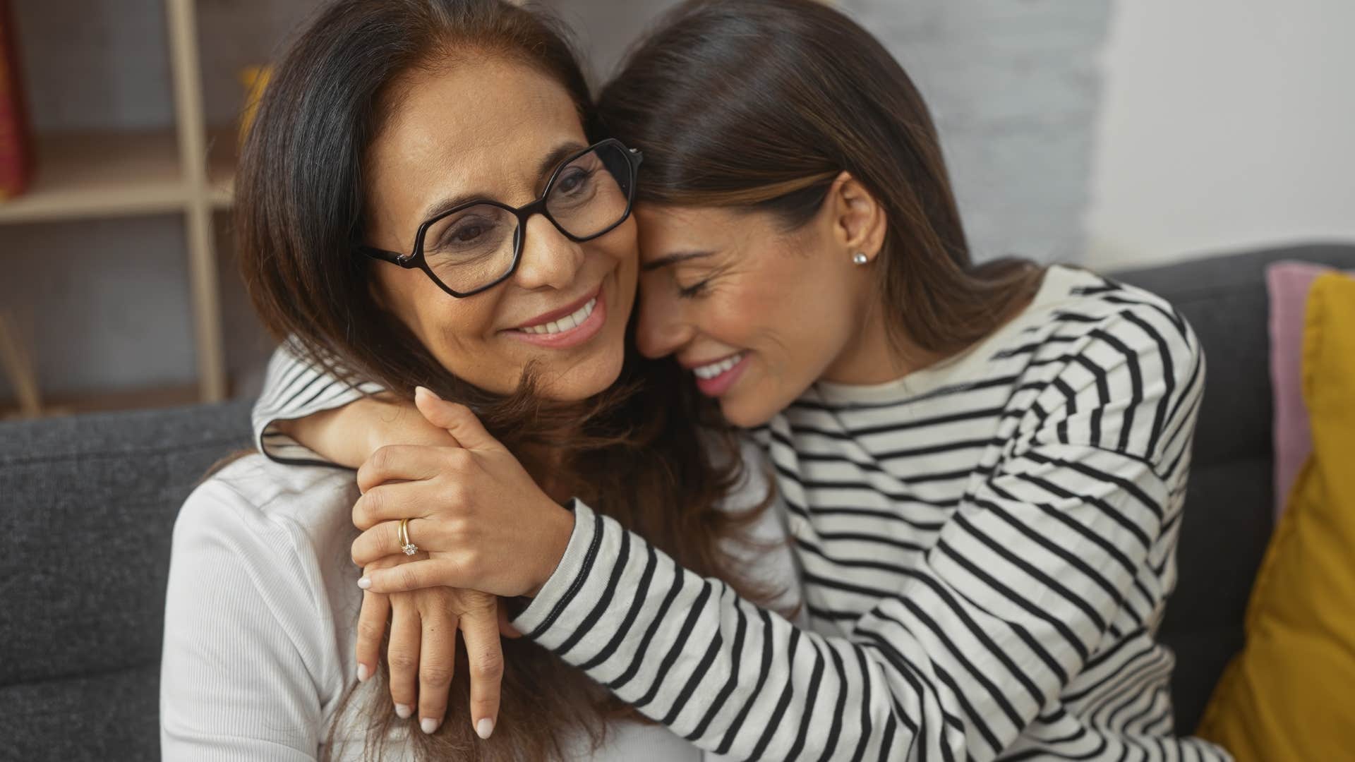 Daughter and mother who don't argue hugging each other.