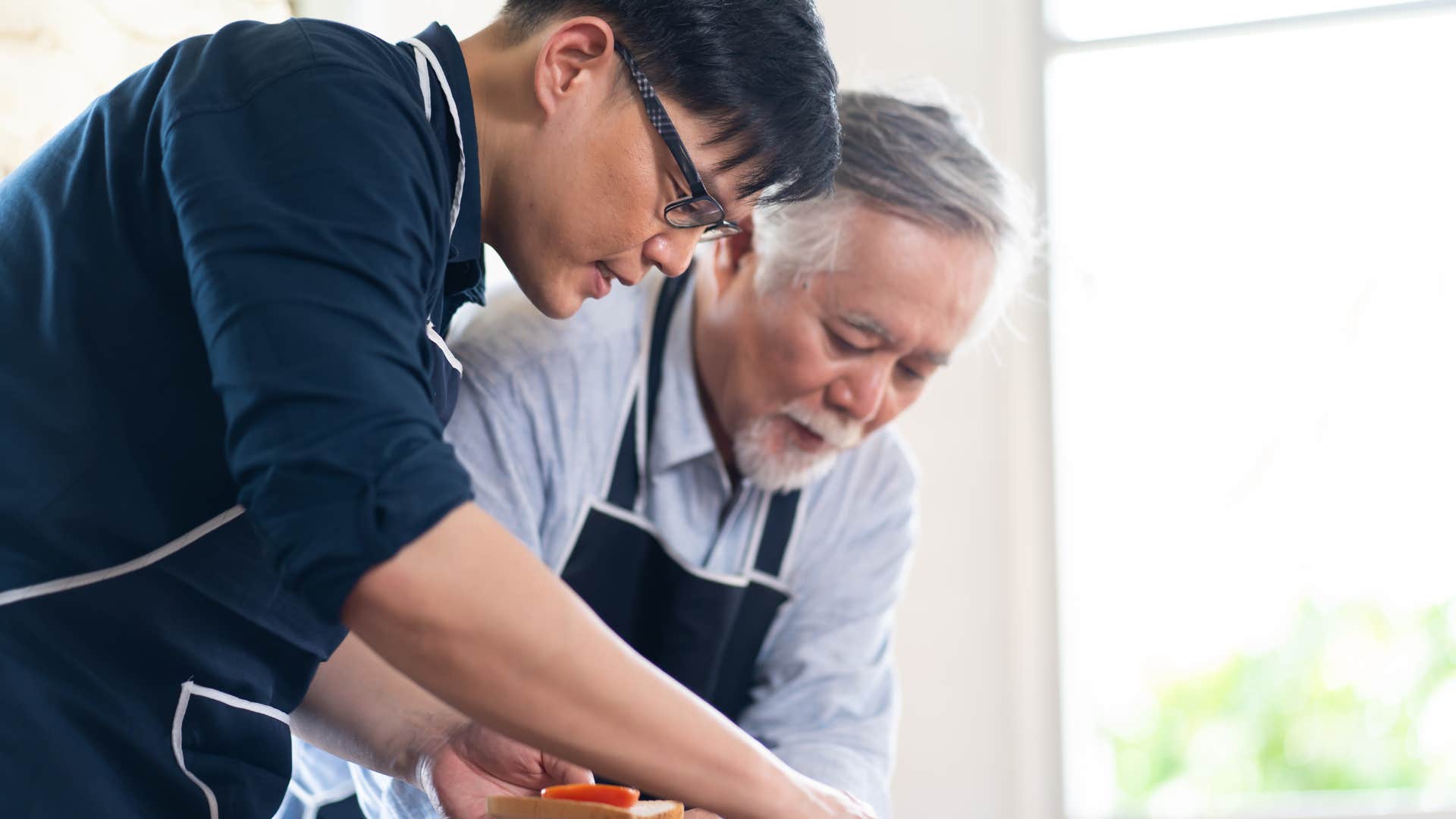 Man who want similar things out of life with his father cooking in the kitchen.
