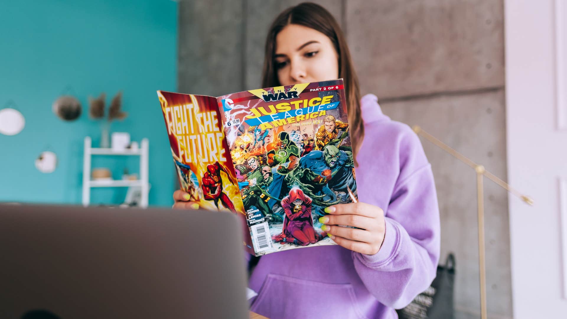 woman with purple hoodie reading comic with favorite character 