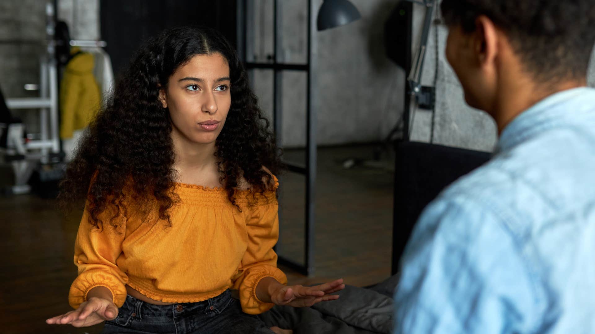 woman in orange shirt not over explaining her no's as she talks to man in blue shirt