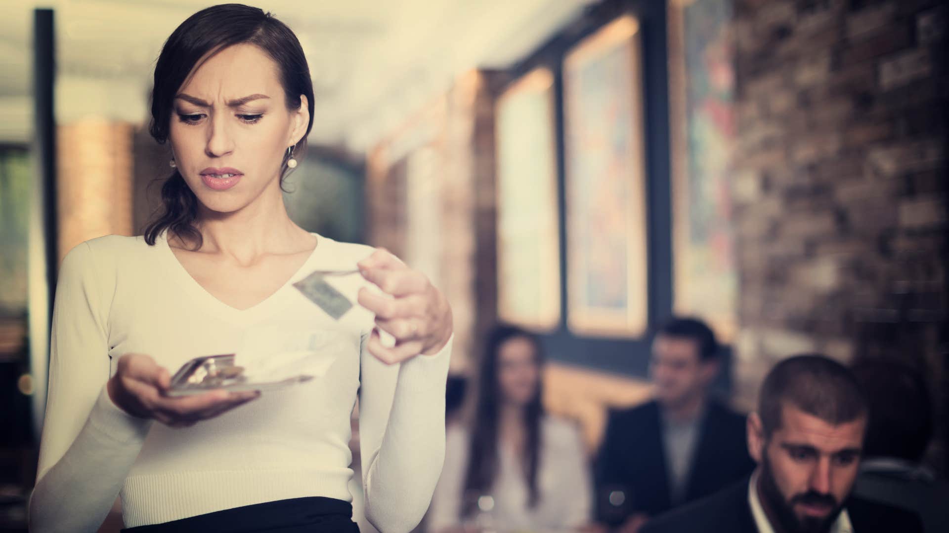 waitress telling herself she will start saving money when she earns more