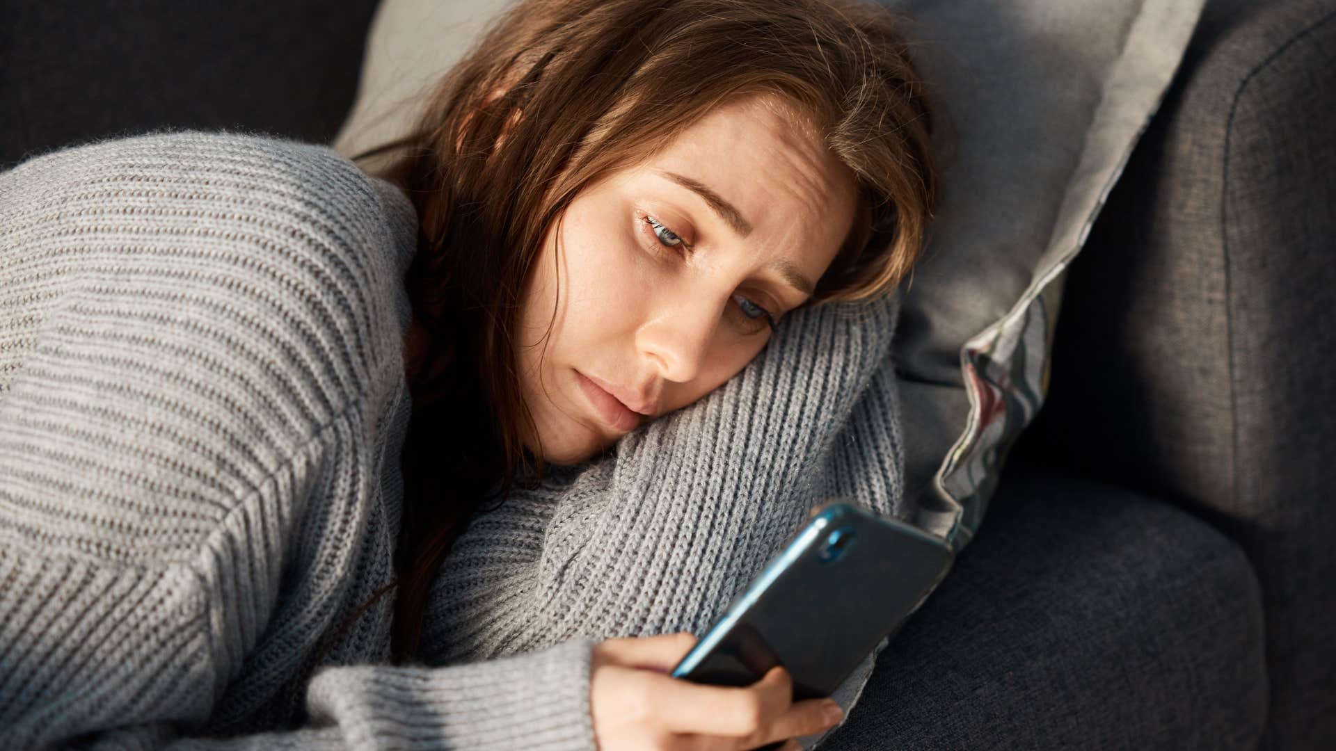 sleepy sad woman texting she didn't see the message on her phone
