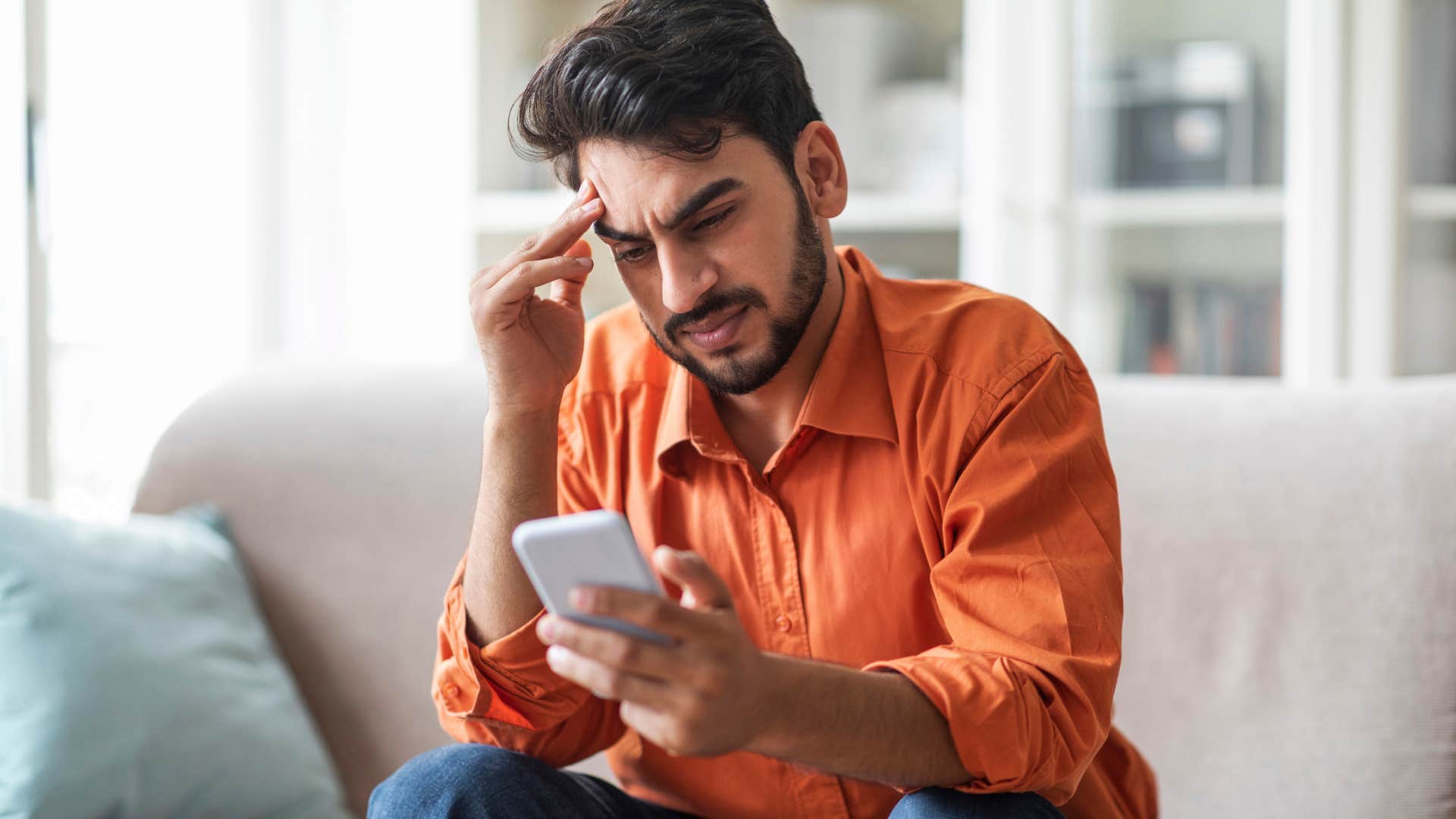 stressed man texting sorry if that was too much on his phone