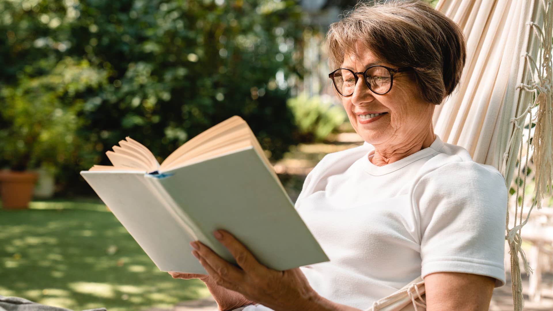 woman who will become a super ager taking her book outside