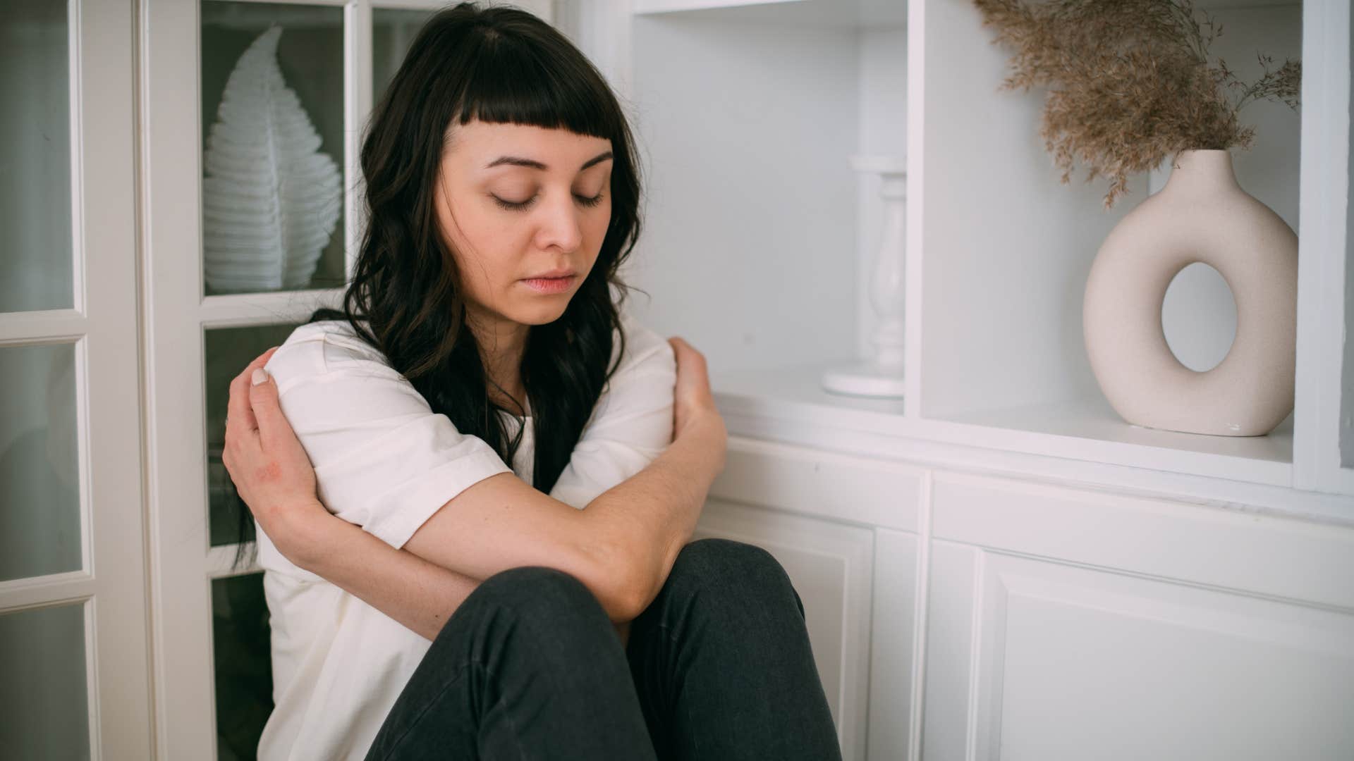 woman holding herself wondering why shes so scared