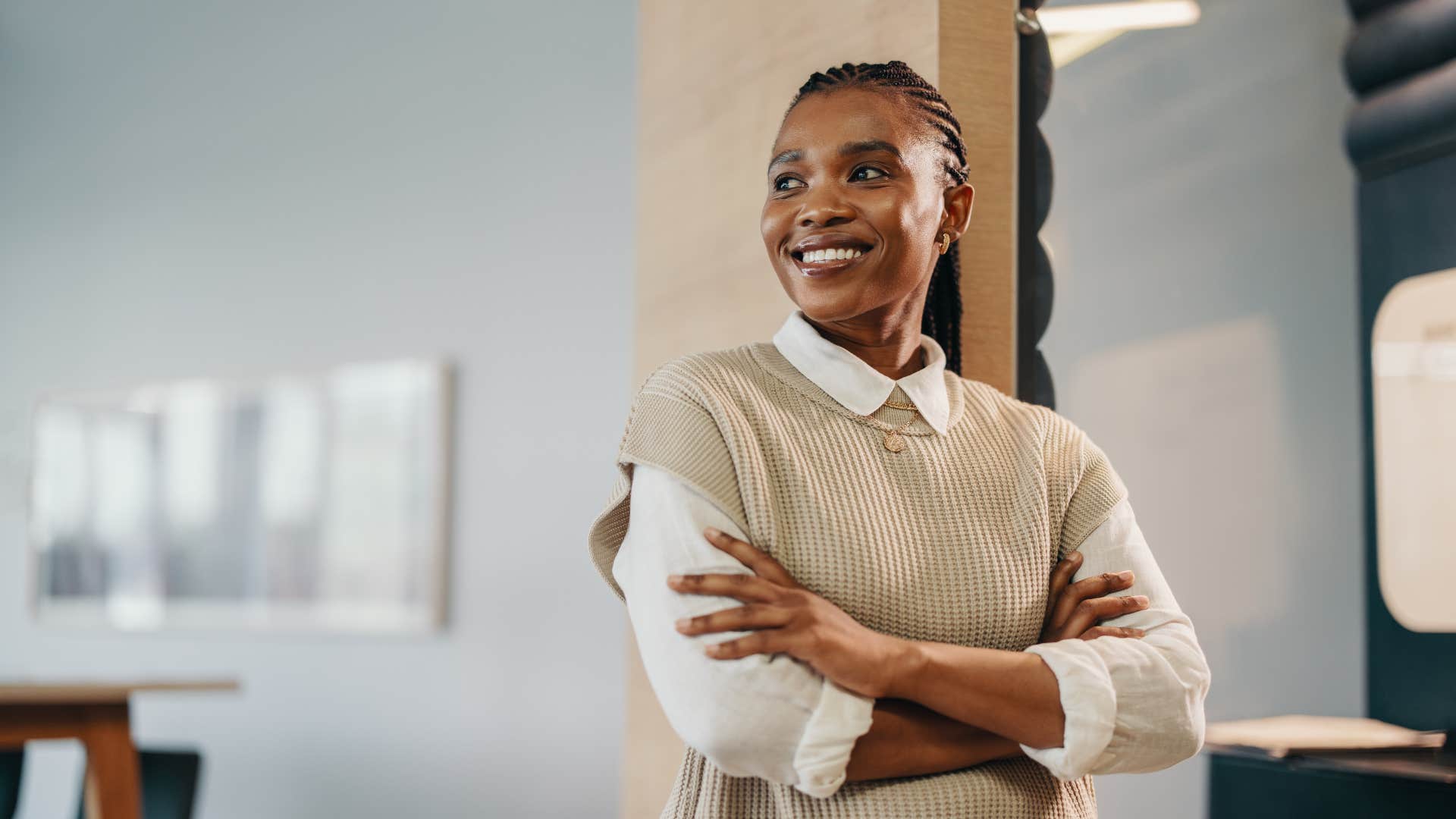 woman smiling and leaning against wall