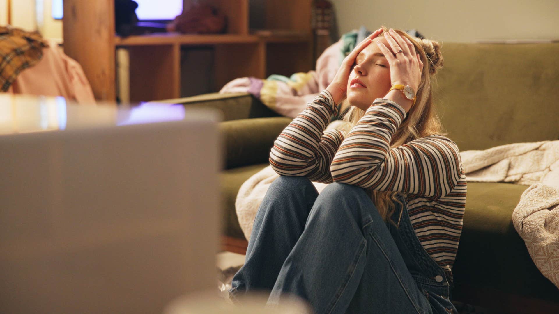 woman feeling stressed sitting on floor