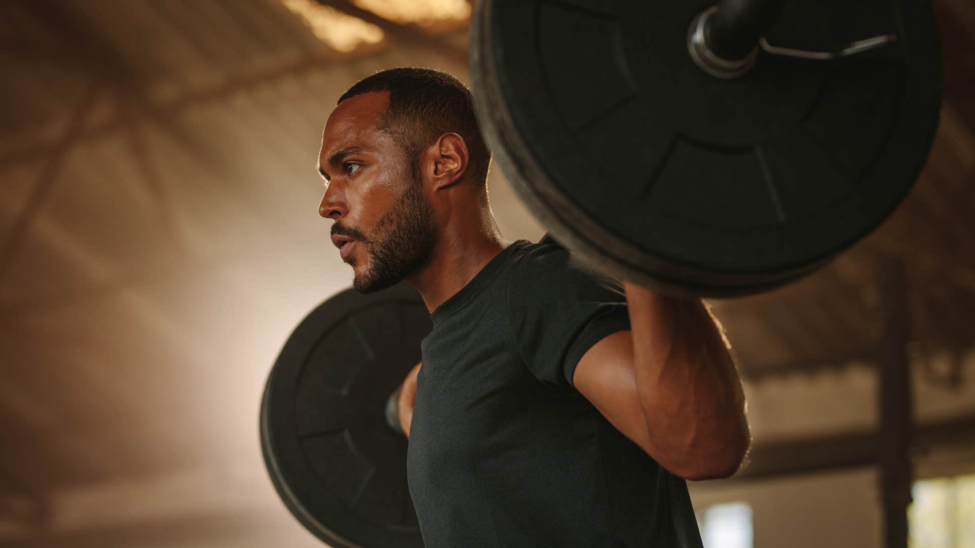 man who looks more youthful lifting something heavy