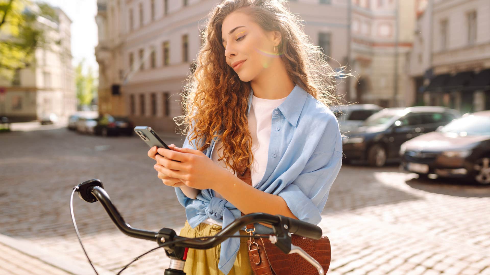 woman looking at phone in street
