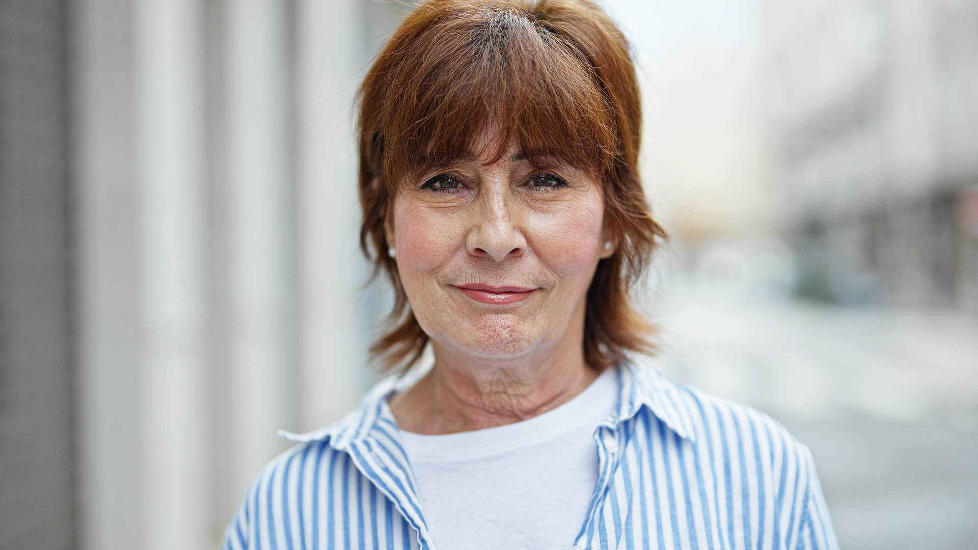 Woman who's secure in their identity smiling at the camera.
