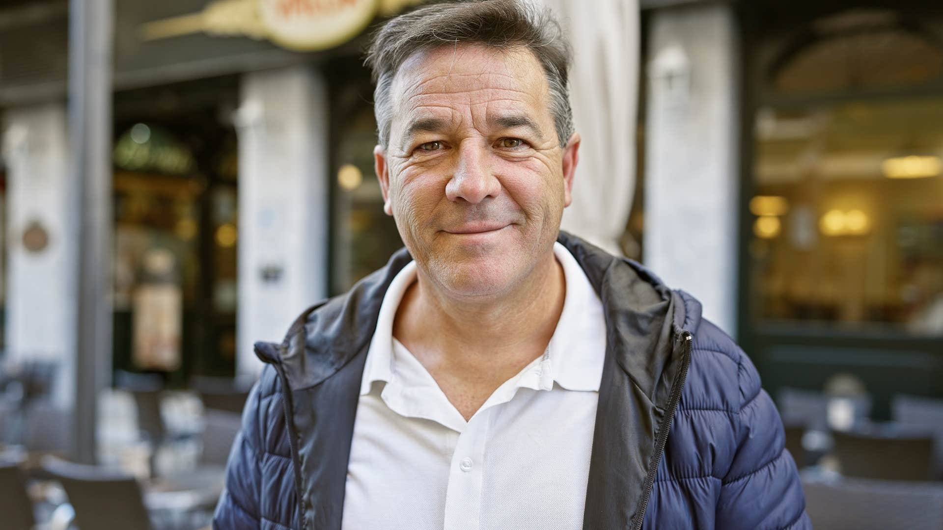 Man whose time feels more valuable smiling at the camera.