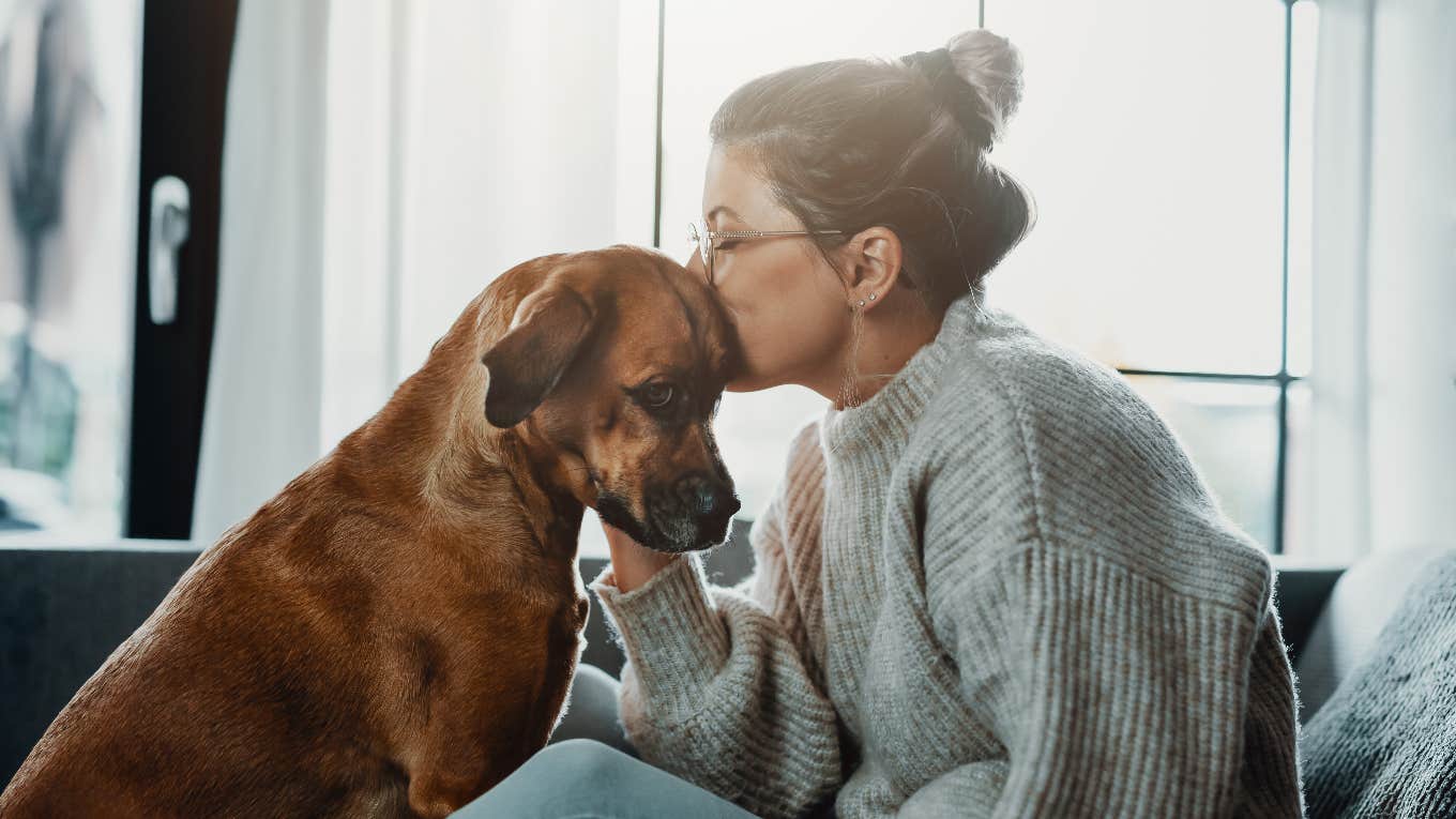 dog owner with specific personality traits cuddling with dog
