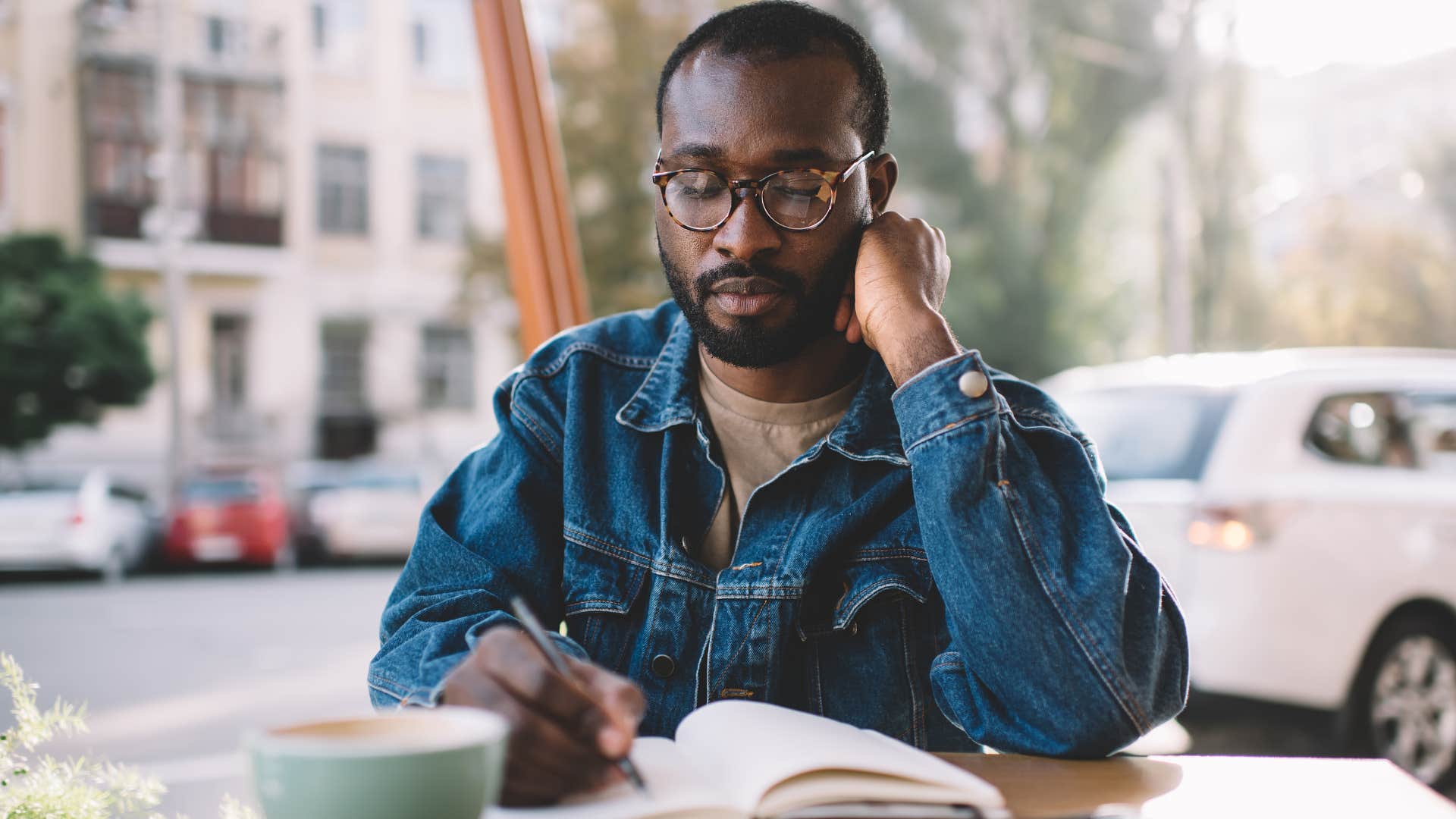 Man who protects their peace journaling.