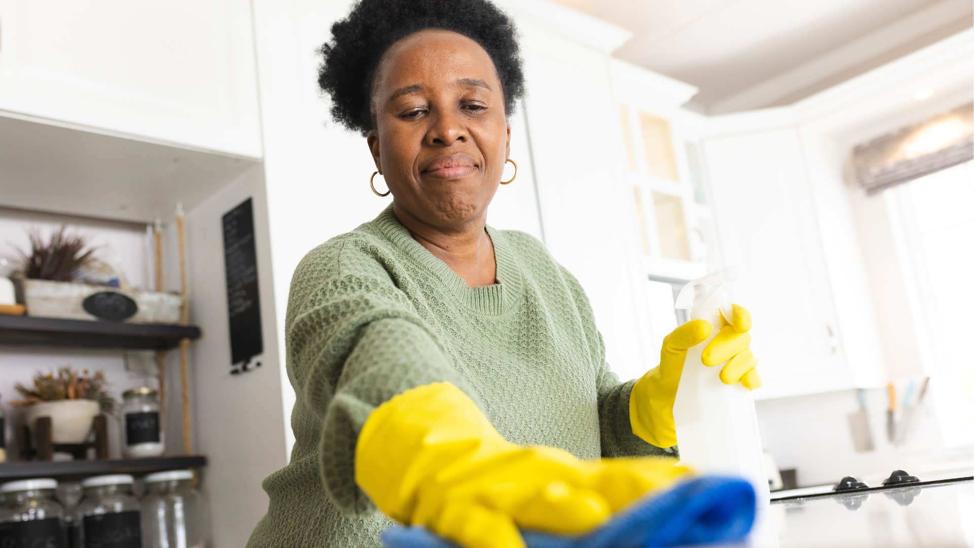 Woman who likes to reset their lives cleaning in the kitchen.
