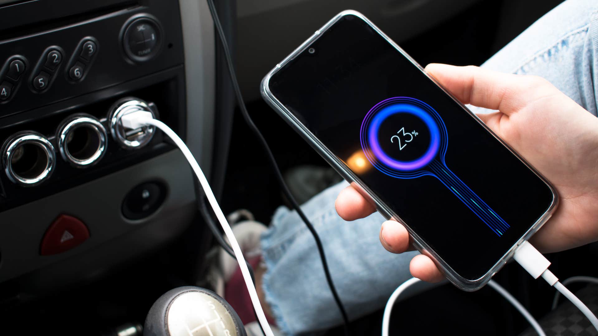 a high iq woman has a phone charger in her car so that a passenger can charge her phone