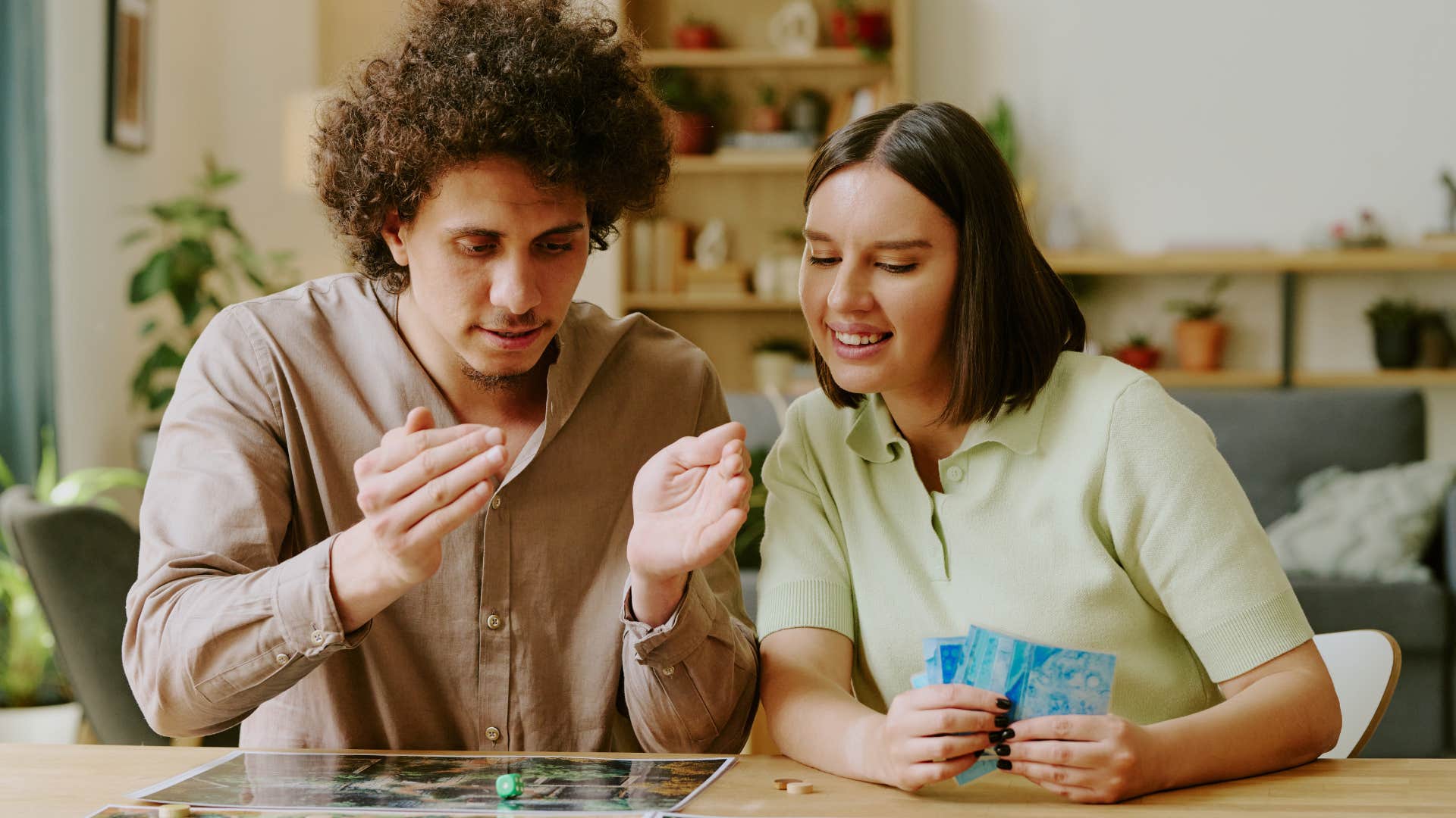 Couple playing board games at home.