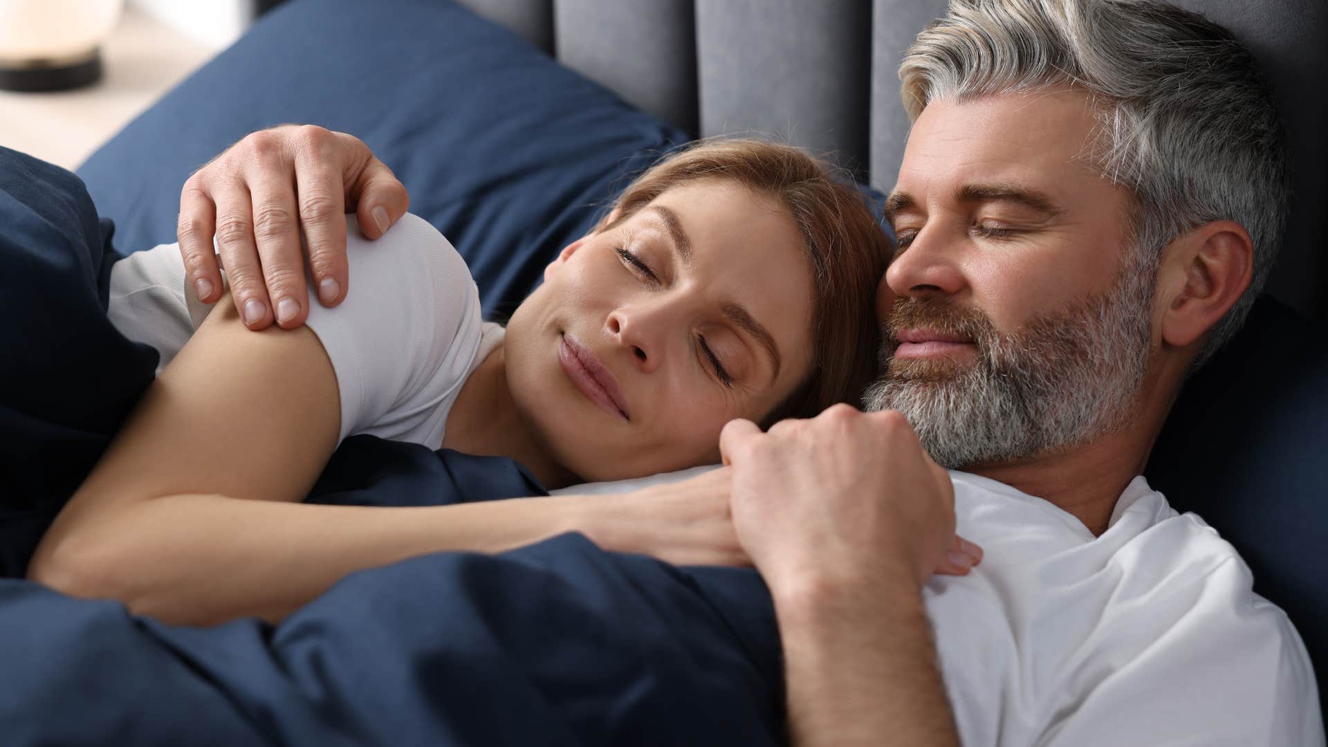 Happy couple laying on a comfortable mattress.