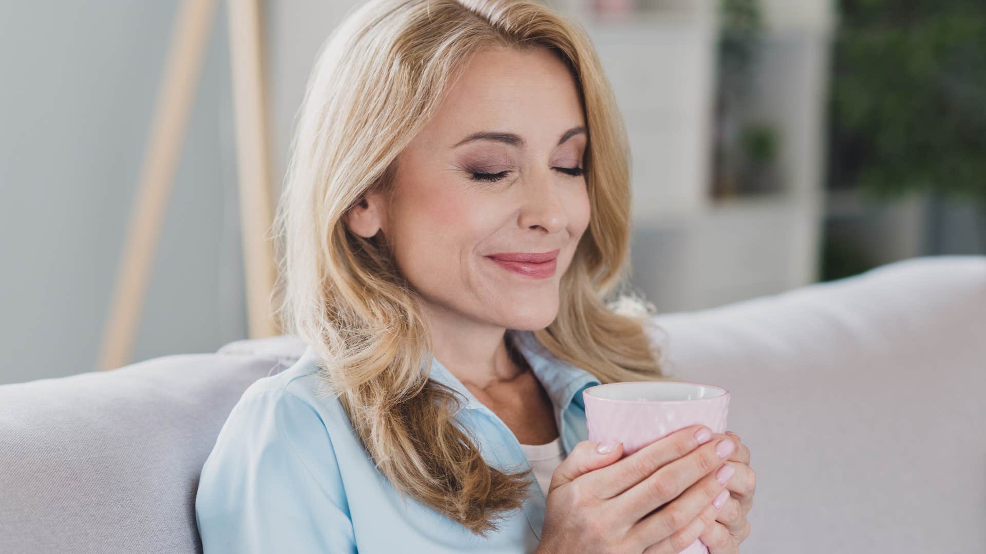 Woman smiling with coffee in her space for solitude.