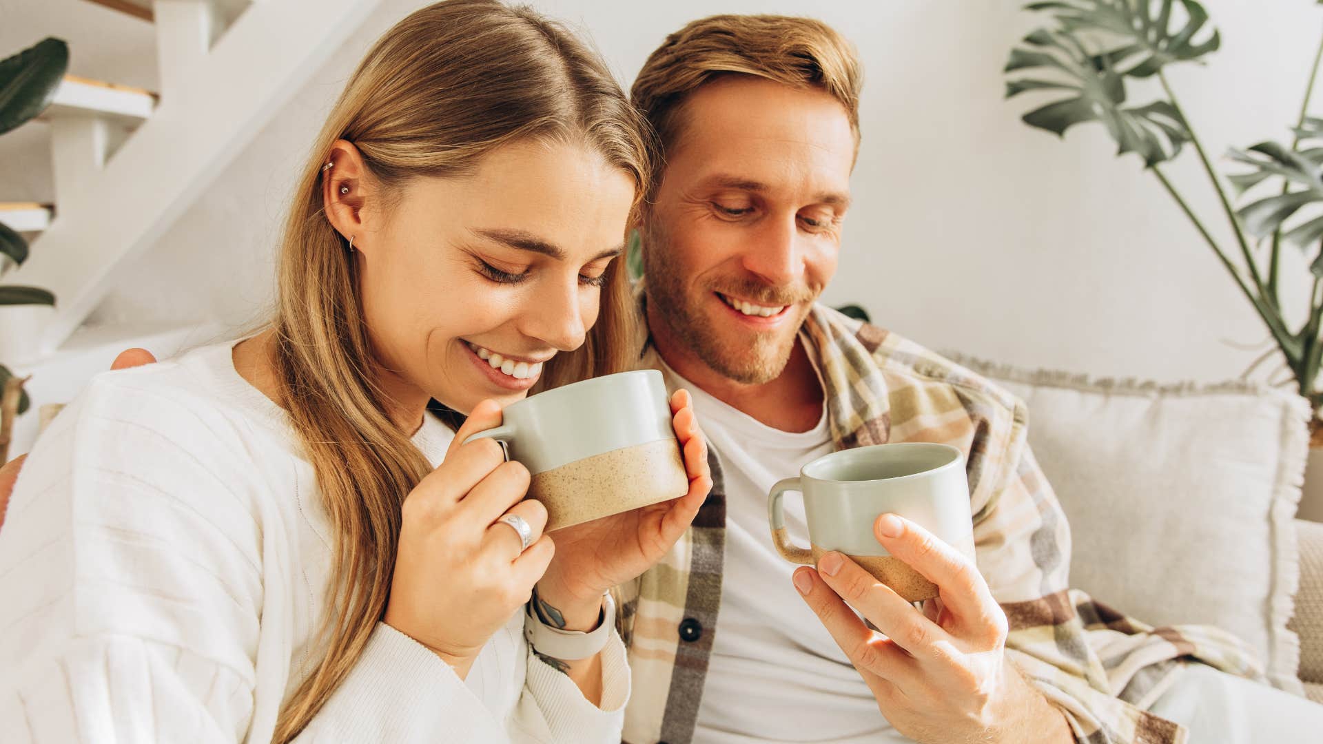 Couple who buys two kinds of various items drinking coffee together at home.