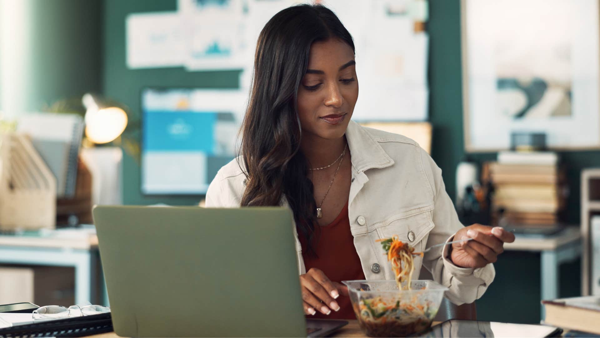 a woman eats while in a work meeting