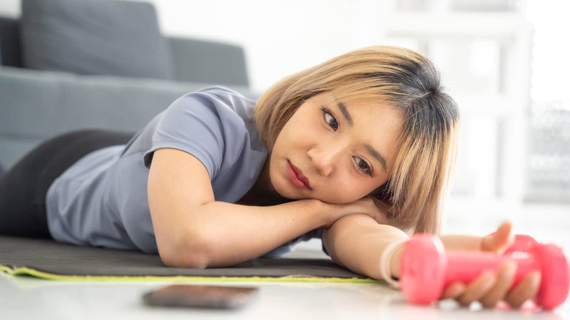 a lazy woman tells her friend over the phone that she is swamped with work but is not doing anything